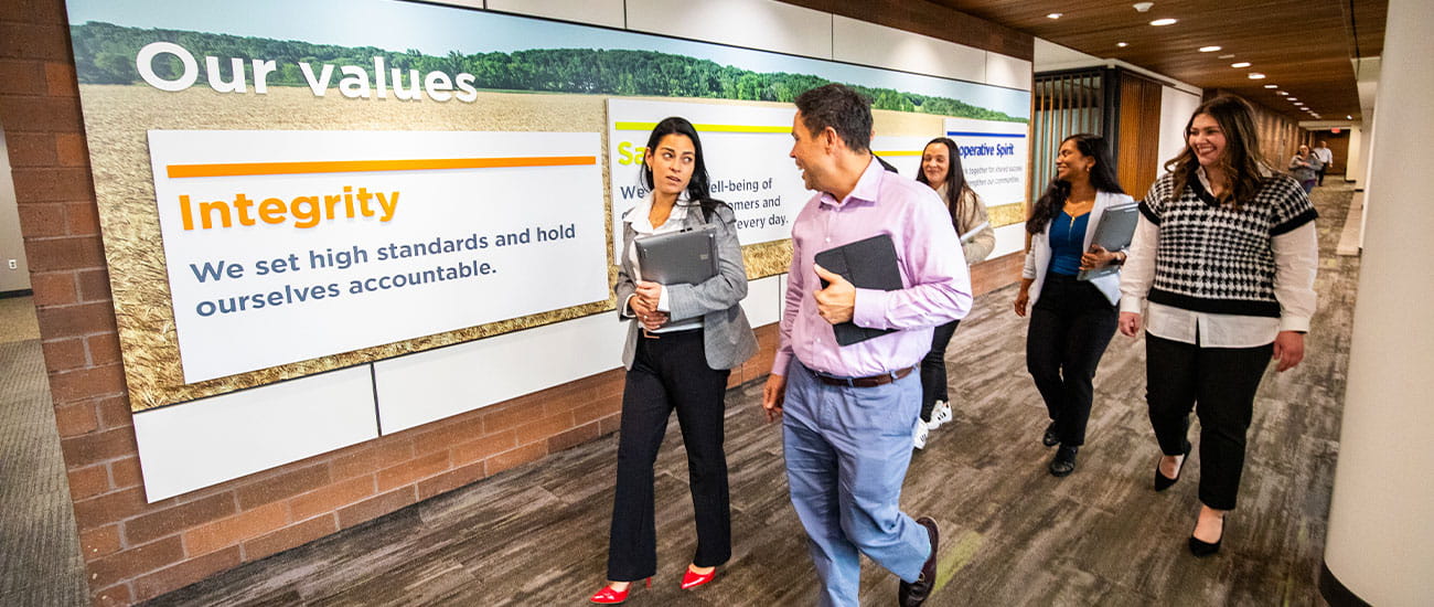 group walking by CHS company values on wall